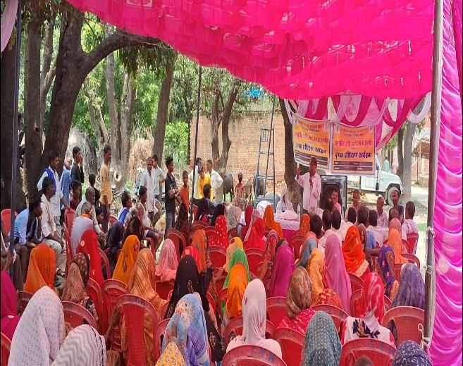 Farmers and farm women seated under a shamiana at a Scheduled Caste Sub-Plan training programme