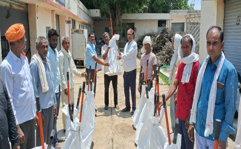 Farmers receiving agriculture tool kits at a distribution programme
